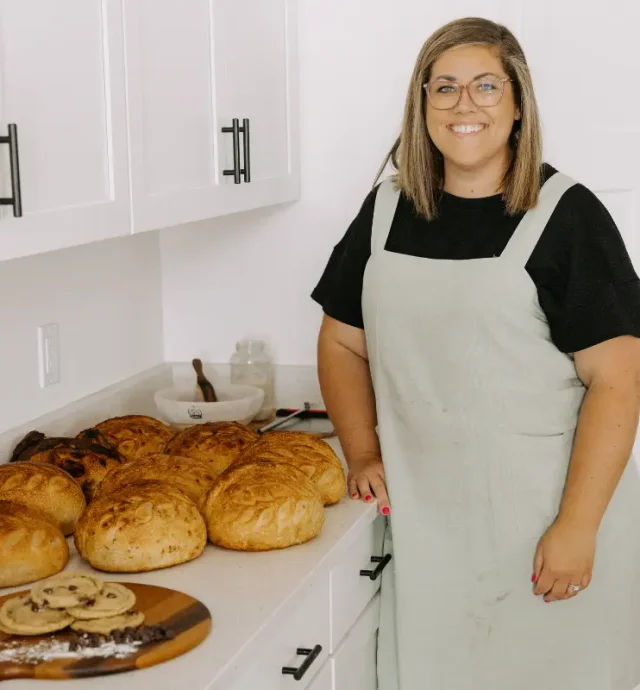 Elise in her kitchen with a fresh batch of bread and cookies.